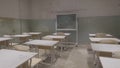 Empty classroom with wooden desks, white and green chalk boards in school. empty classroom. Abandoned School classroom Royalty Free Stock Photo