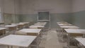 Empty classroom with wooden desks, white and green chalk boards in school. empty classroom. Abandoned School classroom Royalty Free Stock Photo