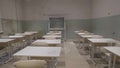 Empty classroom with wooden desks, white and green chalk boards in school. empty classroom. Abandoned School classroom