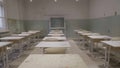 Empty classroom with wooden desks, white and green chalk boards in school. empty classroom. Abandoned School classroom Royalty Free Stock Photo