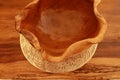 Empty clay bowls on a wooden table. Top view. Close up of a carved wooden bowl. Decorative wooden bowl, artwork Royalty Free Stock Photo