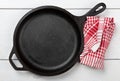 Empty, clean black cast iron pan or dutch oven top view from above on white table with towel Royalty Free Stock Photo