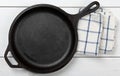 Empty, clean black cast iron pan or dutch oven top view from above on white table with towel Royalty Free Stock Photo