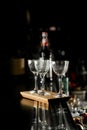 Empty clean glasses for alcoholic drinks in restaurant on bar counter with bottle on blurred background Royalty Free Stock Photo