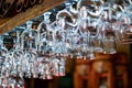 Empty clean glasses for champagne hanging over the bar counter. Crystal glasses for alcohol hung in the bar. Close-up Royalty Free Stock Photo