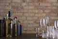 Bar counter and bottle of drinks, glassware on it, vintage red brick wall.Empty space for text Royalty Free Stock Photo
