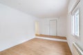 Empty clean room after renovation with white walls, window and wooden floor Royalty Free Stock Photo