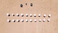 An empty clean sandy beach with two rows of parasols and cabanas, aerial view. Royalty Free Stock Photo