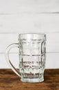 Empty clear beer glass, mug on wooden table. Vertical Royalty Free Stock Photo