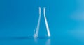 Empty Glass Erlenmeyer Flask on a Blue Background laboratory science Royalty Free Stock Photo