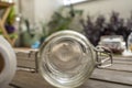 Empty clear glass jar with vacuum seal on acacia wood planks and plants in the background Royalty Free Stock Photo