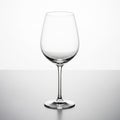 Empty Clear Glass Wine Goblet on Reflective Surface with White Background wine glass Royalty Free Stock Photo