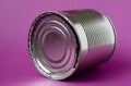 Empty closed tin can lies on a purple background Royalty Free Stock Photo