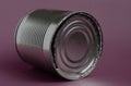 Empty closed tin can lies on a purple and gray background Royalty Free Stock Photo