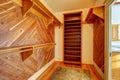 Empty closet with wood paneled walls