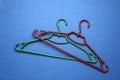 Empty clothes hangers on blue background, flat lay Royalty Free Stock Photo