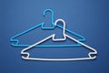 Empty clothes hangers on blue background, flat lay Royalty Free Stock Photo