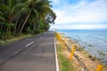 Empty coastal road by the sea. Tropical island holiday travel. Royalty Free Stock Photo