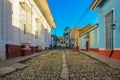 Empty cobblestone street with colonial colorful houses in Trinidad, Cuba. Beautiful Caribbean cityscape. UNESCO site famous Royalty Free Stock Photo
