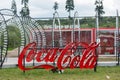 Empty Coca Cola bottles are arranged in a shape