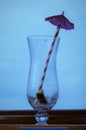 Empty cocktail glass with umbrella and straw Royalty Free Stock Photo