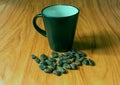 Empty coffee cup and coffee beans on colored background