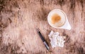 Empty coffee cup, crumpled sheet of paper and pen on wooden table. Dirty coffee cup on wooden table. Royalty Free Stock Photo