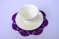 Empty coffee cup and saucer on violet coaster Royalty Free Stock Photo