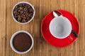 Empty coffee cup, spoon, bowls with coffee beans, ground coffee