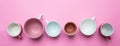 Empty coffee cups white and pink color against pink background, banner Royalty Free Stock Photo