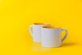 Empty coffee or tea white cup with yellow on yellow background. Copy space for text Royalty Free Stock Photo