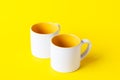 Empty coffee or tea white cup with yellow on yellow background. Copy space Royalty Free Stock Photo