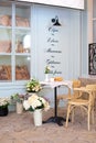 Empty coffee terrace with French-style tables and chairs. View of terrace on street. Vintage street cafe with cup of coffee and cr