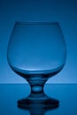 Empty cognac glass studio light blue shot 7 Royalty Free Stock Photo