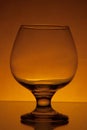 Empty cognac glass studio light yellow shot 8 Royalty Free Stock Photo