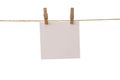 Empty color paper sheets for notes, frames that hang on a rope with clothespins and isolated on white