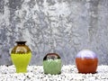 Empty colorful ceramic vases decoration on white gravel piles.