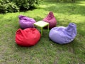 Empty colorful chair bags in park and table, rest and relaxation area concept Royalty Free Stock Photo