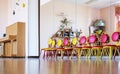 Empty colorful children chairs standing on wooden floor in music class Royalty Free Stock Photo
