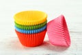 Empty colorful cupcake cases on wooden background Royalty Free Stock Photo