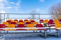 Empty Colorful Football Soccer Stadium Seats in the Winter Covered in Snow - Sunny Winter Day with Clear Blue Sky in the Royalty Free Stock Photo