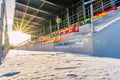 Empty Colorful Football & x28;Soccer& x29; Stadium Seats in the Winter Covered in Snow - Sunny Winter Day with Sun Flare Royalty Free Stock Photo