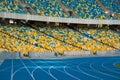 Empty colorful stadium seats and running tracks. Royalty Free Stock Photo