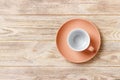 Empty colourful cup on plate for coffee or tea on wood background