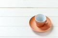 Empty colourful cup on plate for coffee or tea on wood background