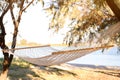 Empty comfortable hammock on beach. Summer vacation Royalty Free Stock Photo