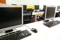 Empty computer classroom with monitors on top of table Royalty Free Stock Photo