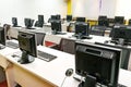 Empty computer classroom with monitors on top of table Royalty Free Stock Photo