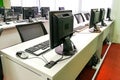 Empty computer classroom with monitors on top of table Royalty Free Stock Photo