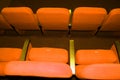 Empty concert hall, theater chairs background ... color photo, empty cinema or concert hall. The red chairs in the